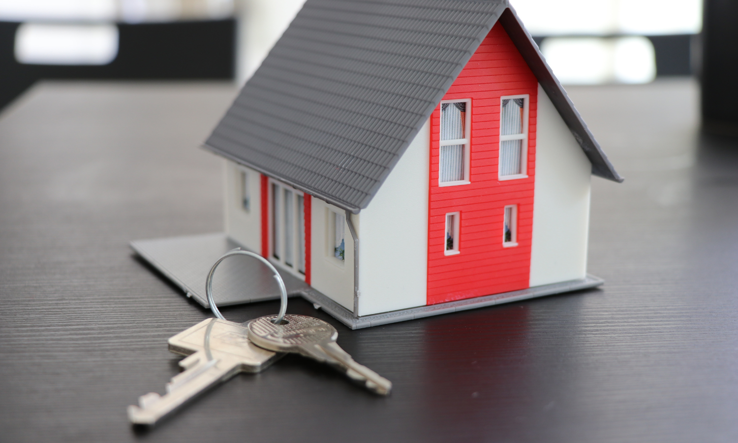 jointly owned property blog- a model house behind a set of house keys