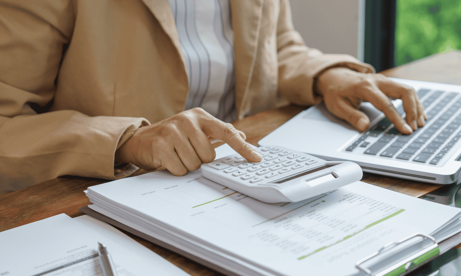 no need to file a tax return blog - person typing on a calculator